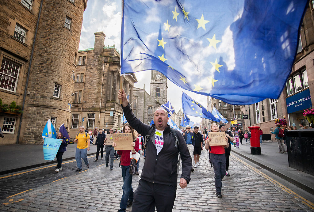 Protesters from the European Movement in Scotland hold a walking vigil outside the Scottish Parliament